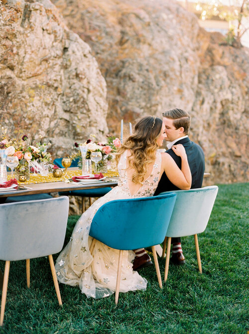 Couple at outdoor table by rocks